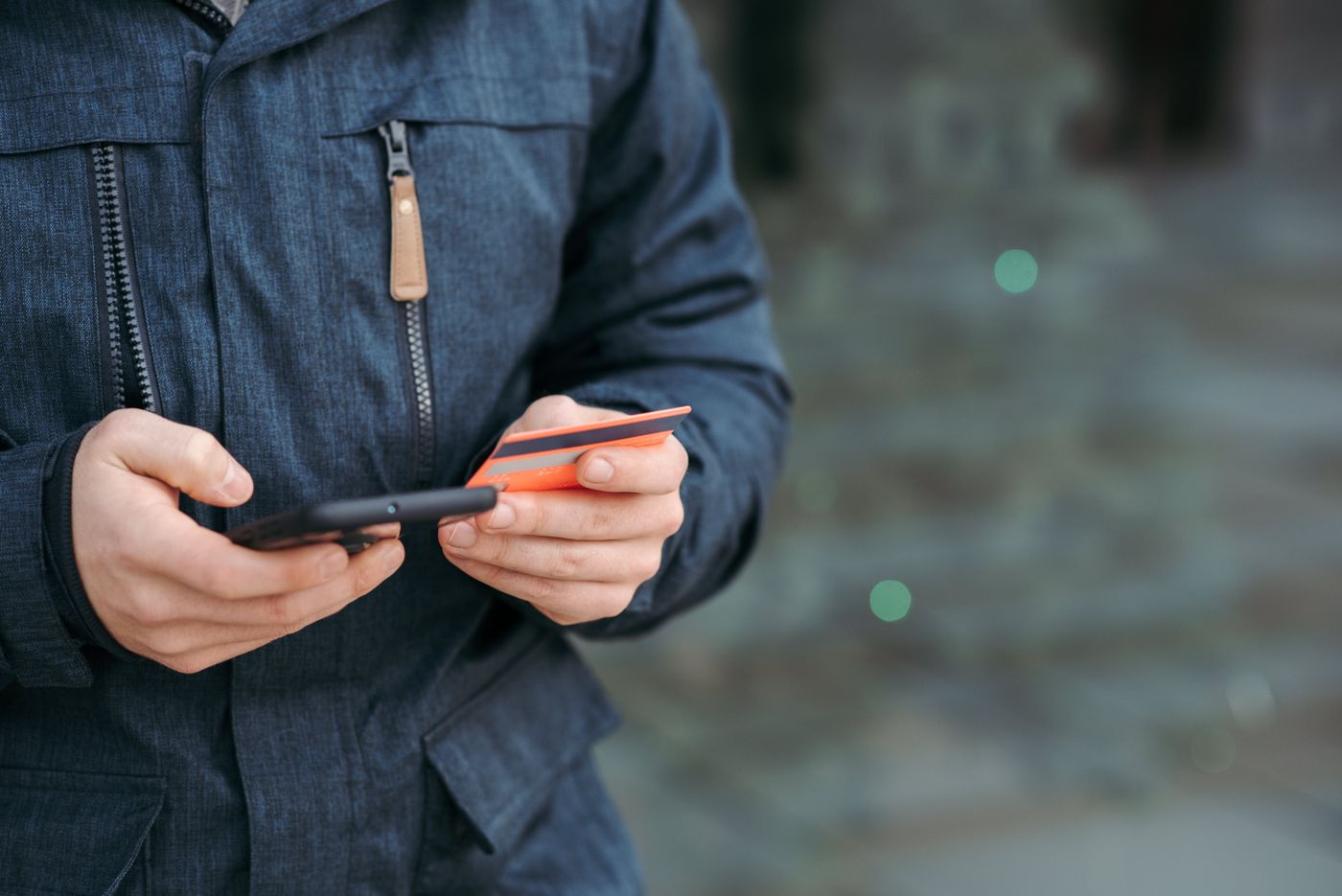 A person comparing a phone purchase with a payment card